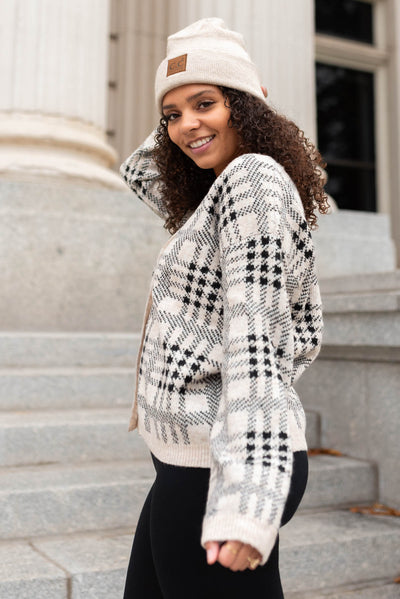 Side view of a taupe button down cardigan