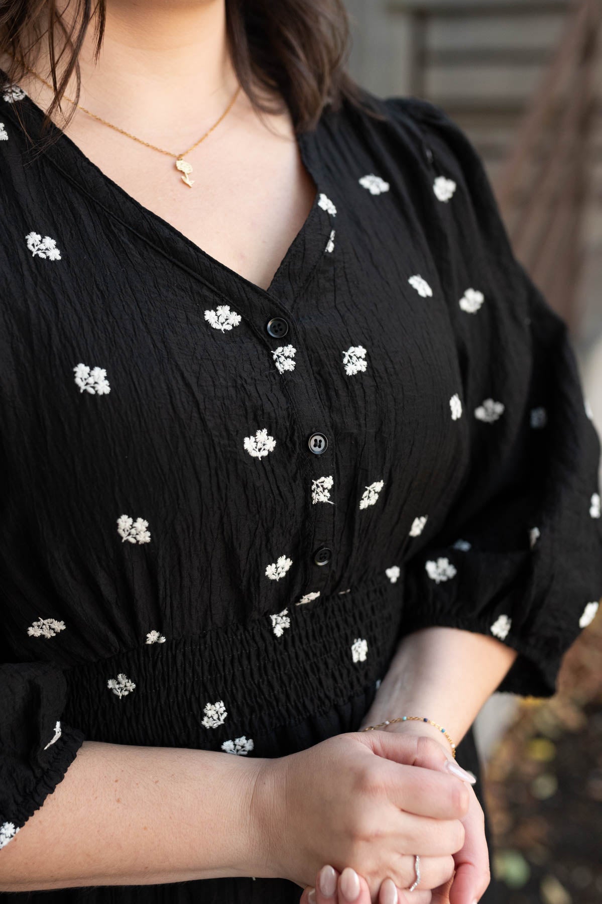 Close up of the flower pattern on the plus size black embroidered button dress