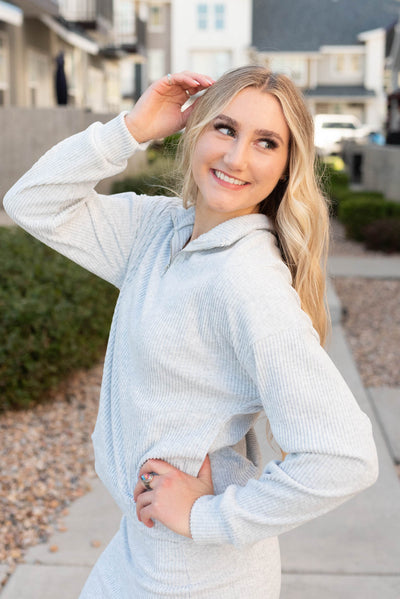 Side view of the grey ribbed knit sweater