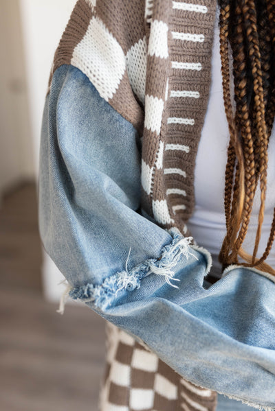 Close up of the distressed denim on the  mocha gingham and denim cardigan