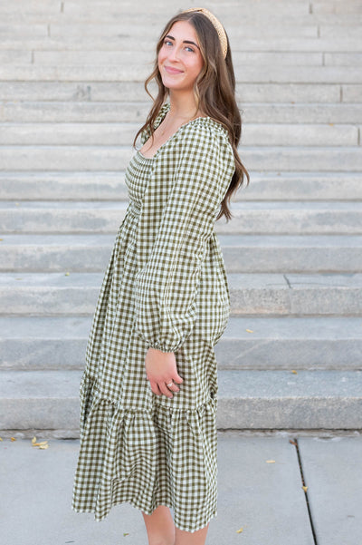 Side view of the olive gingham square neck dress