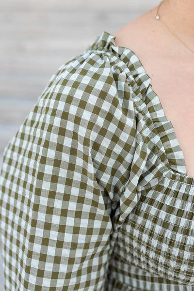 Close up of the fabric on the olive gingham square neck dress