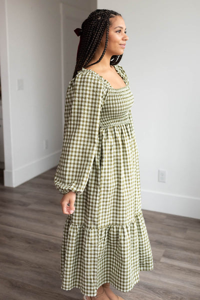 Side view of the olive gingham square neck dress