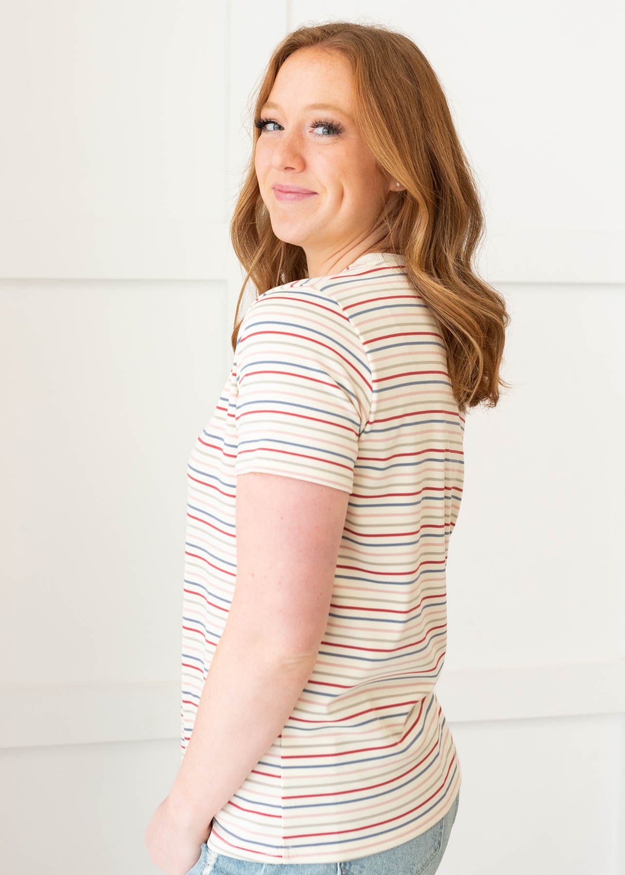 Side view of the ivory multi stripe top