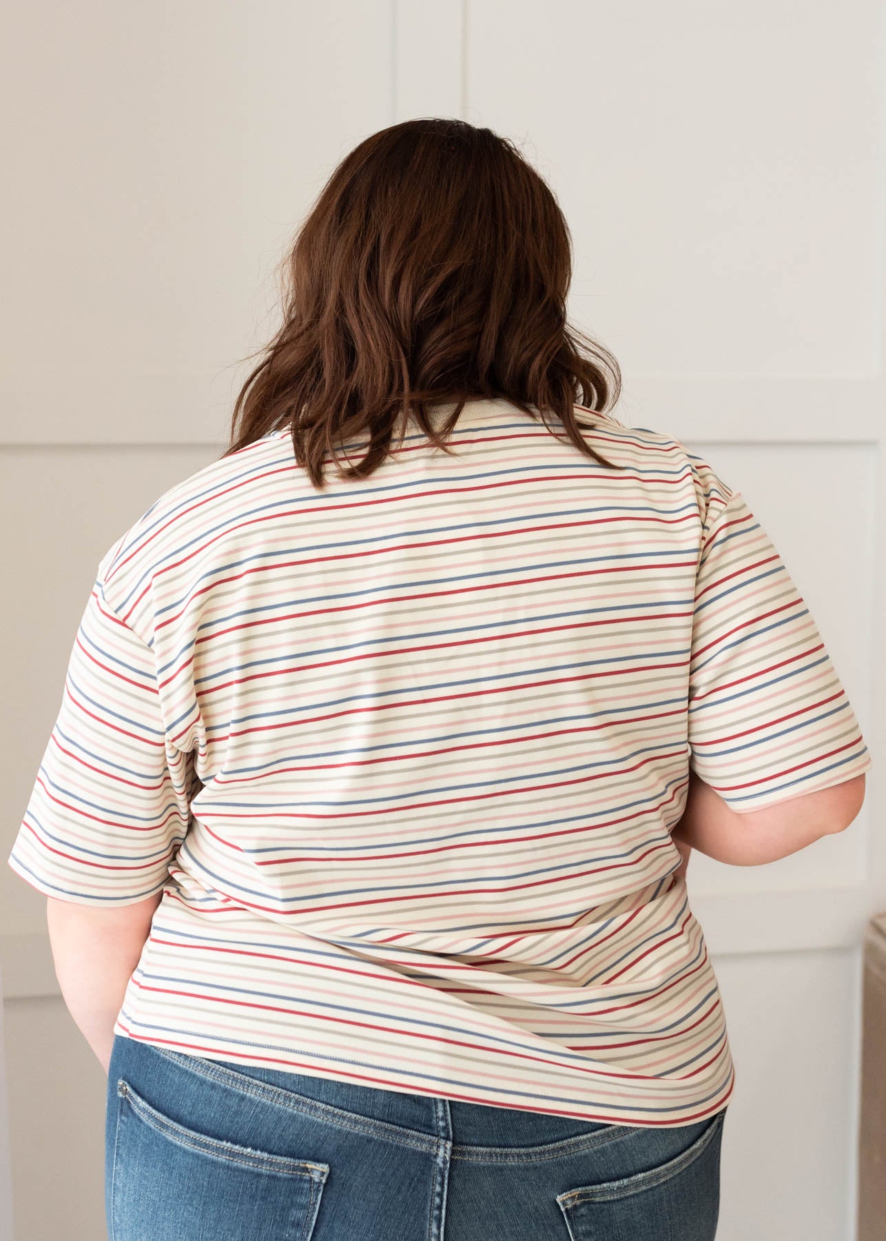 Back view of the plus size ivory multi stripe top