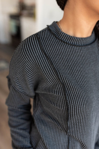 Close up of the fabric on the charcoal ribbed long sleeve top