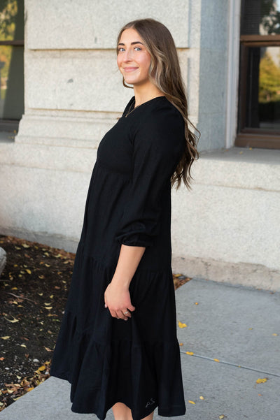 Side view of the black waffle knit dress