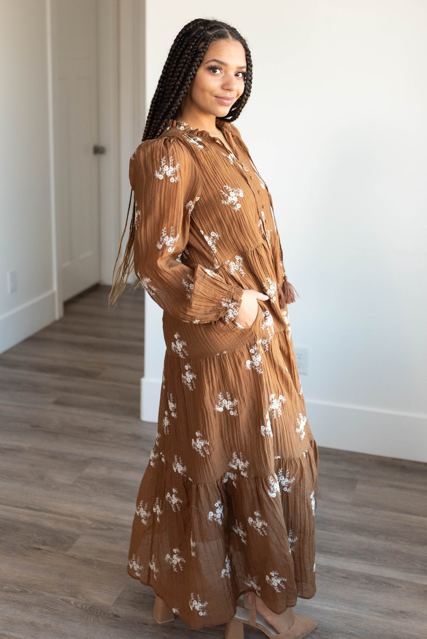 Side view of the brown embroidered dress with pockets