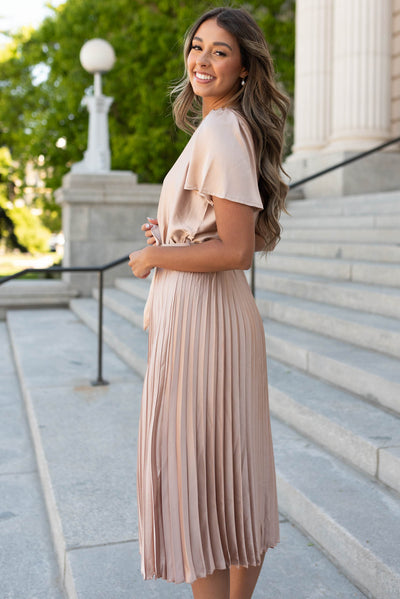 Side view of the champagne satin pleat dress