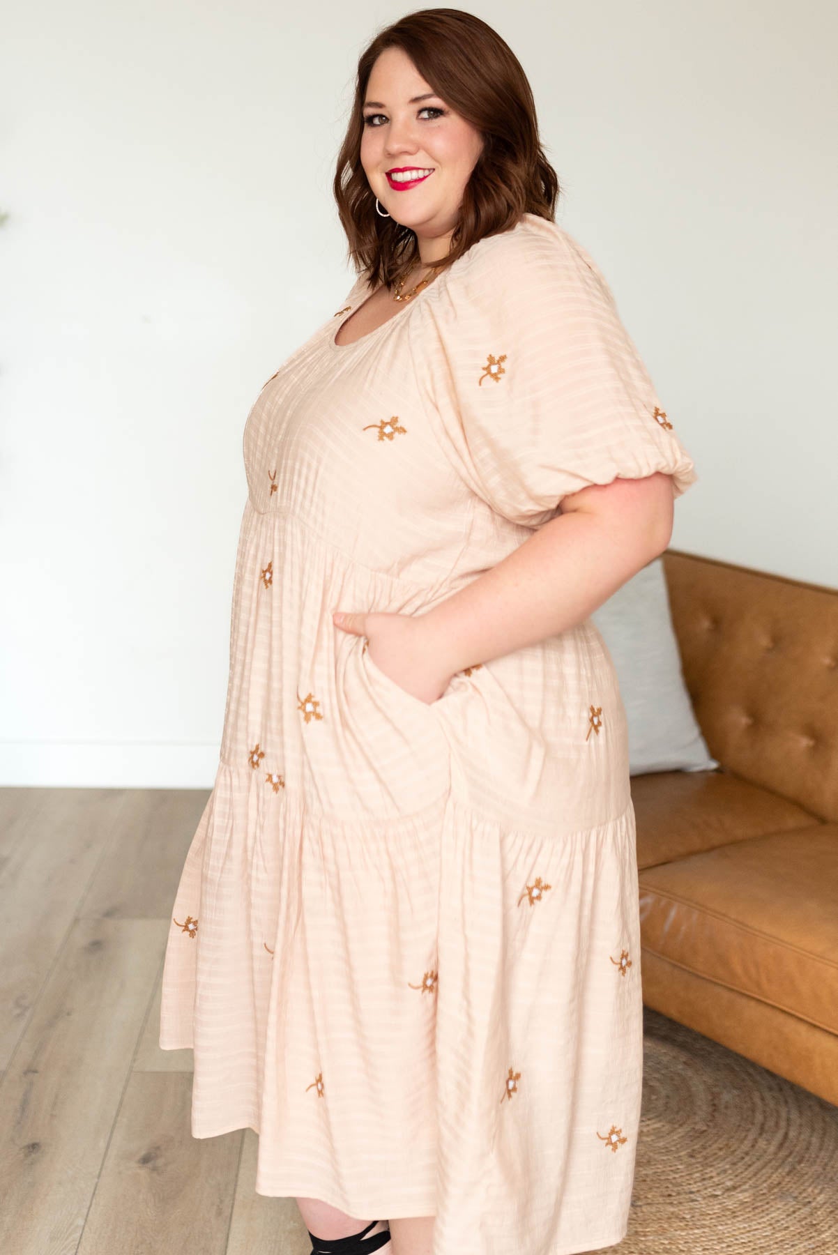 Side view of the plus size natural embroidered loral dress with pockets