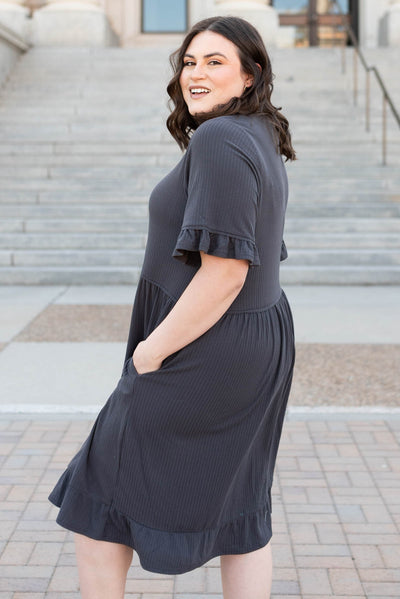 Side view of the plus size charcoal rib knit dress with pockets