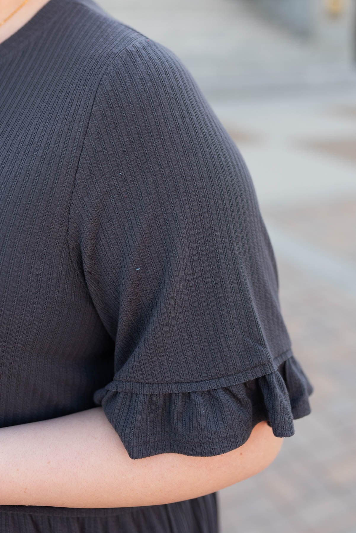 Close up of the sleeve on the charcoal rib knit dress