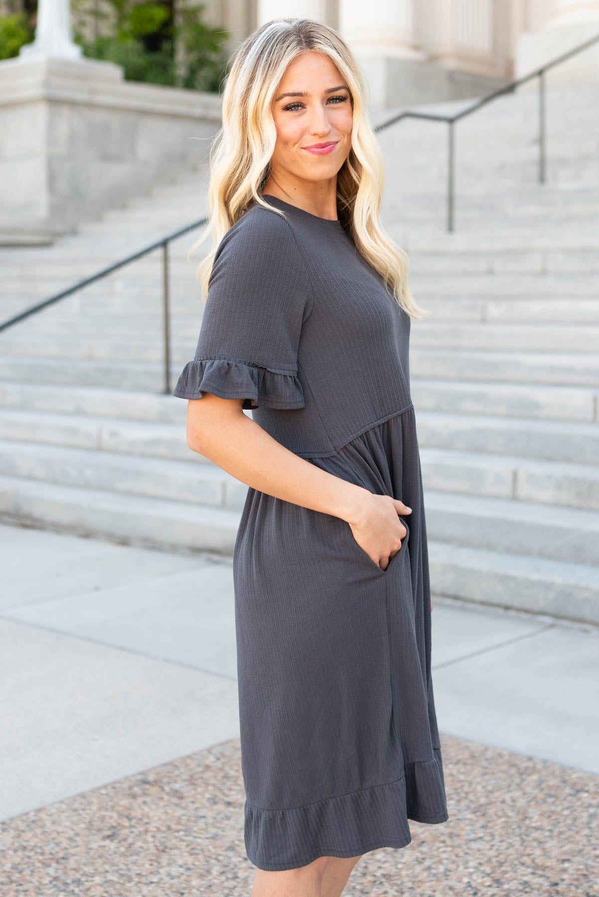 Side view of the charcoal rib knit dress with pockets