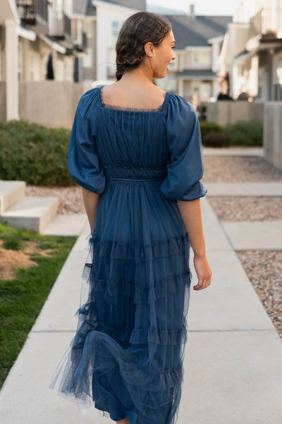 Back view of the navy long sleeve ruffle dress