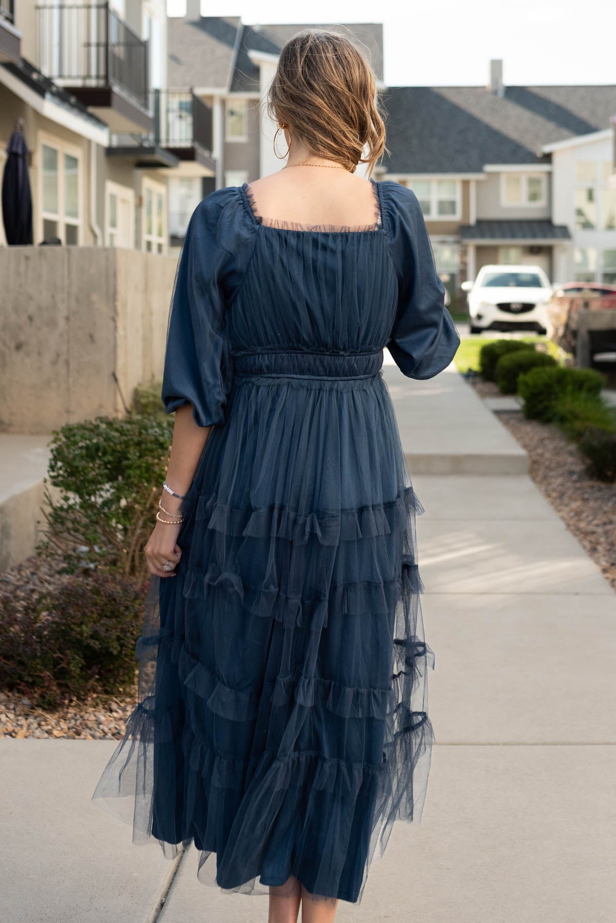 Back view of the navy long sleeve ruffle dress