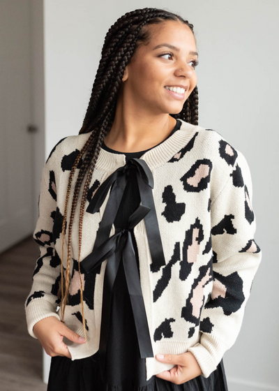 Close up of the cream leopard cardigan with the two ribbons that tie in the front