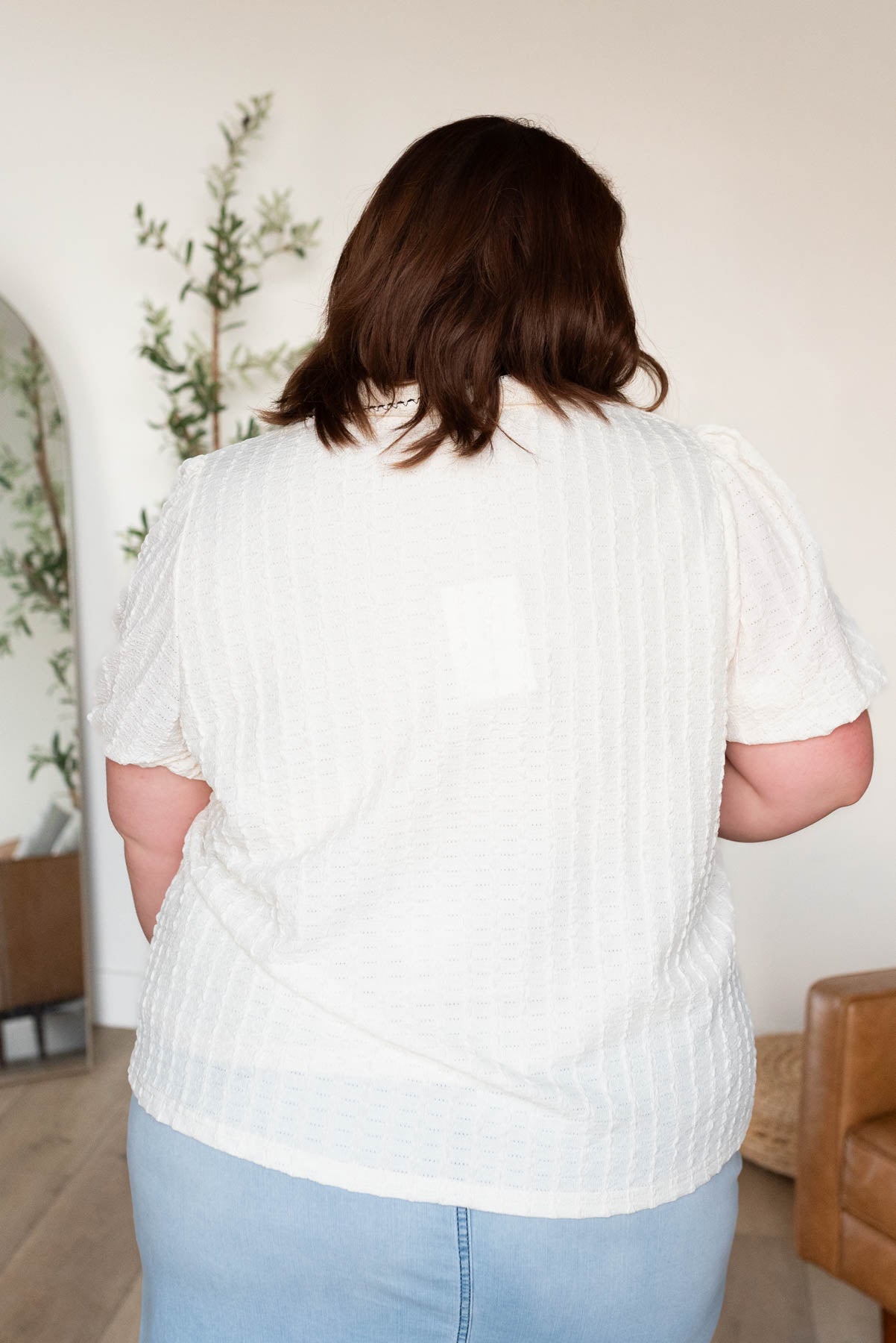 Back view of the cream collared top in plus size