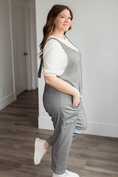 Side view of the charcoal stripe overalls in plus size