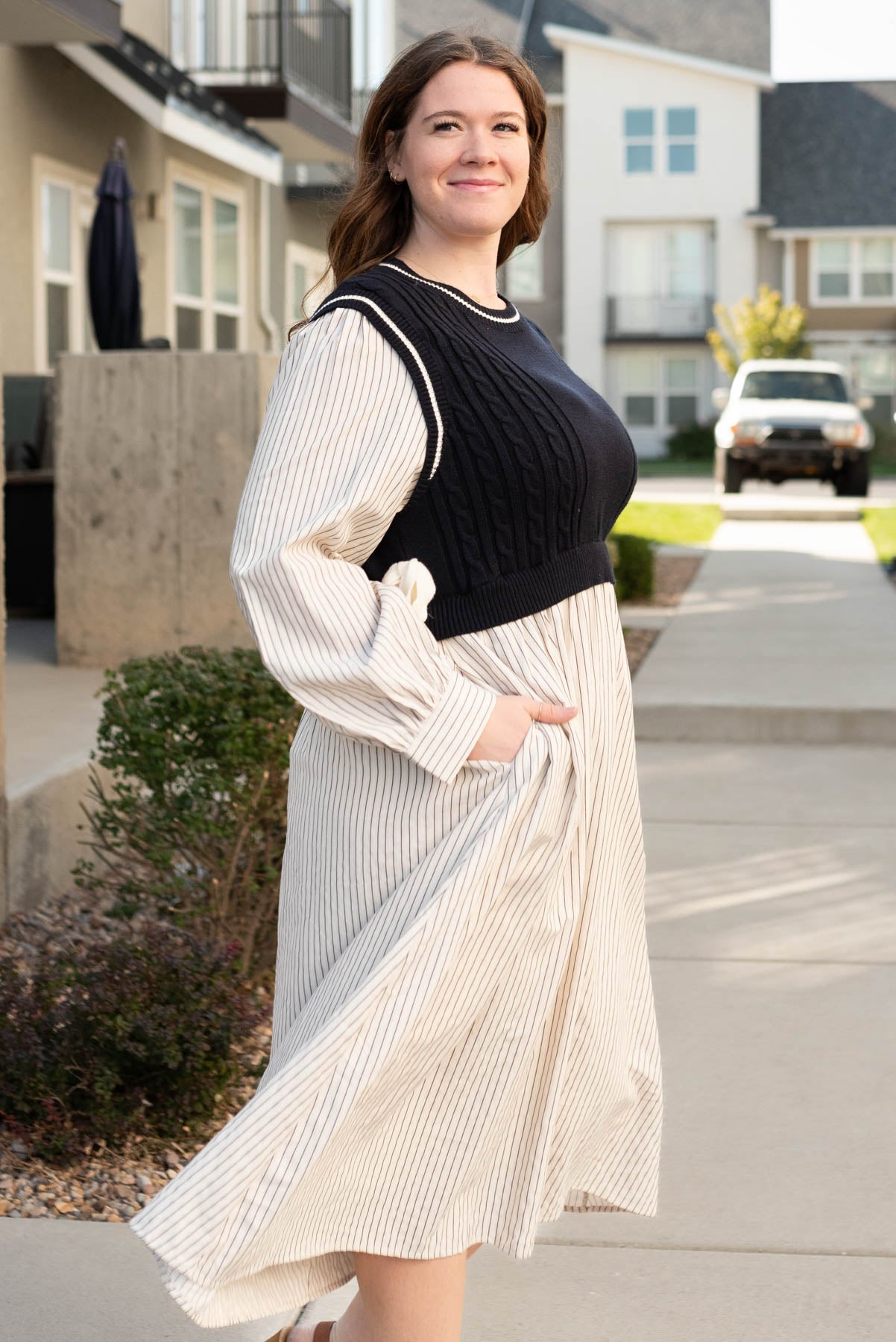 Side view of the navy knit sweater dress in plus size