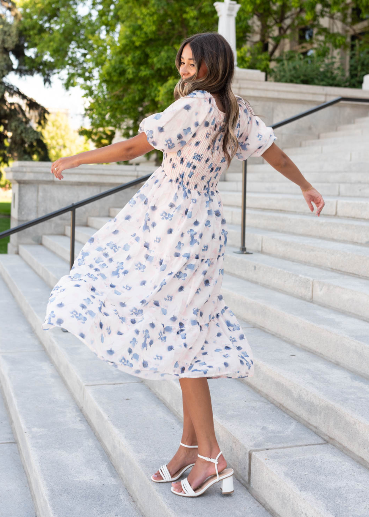 blue floral smocked dress with pale pink background