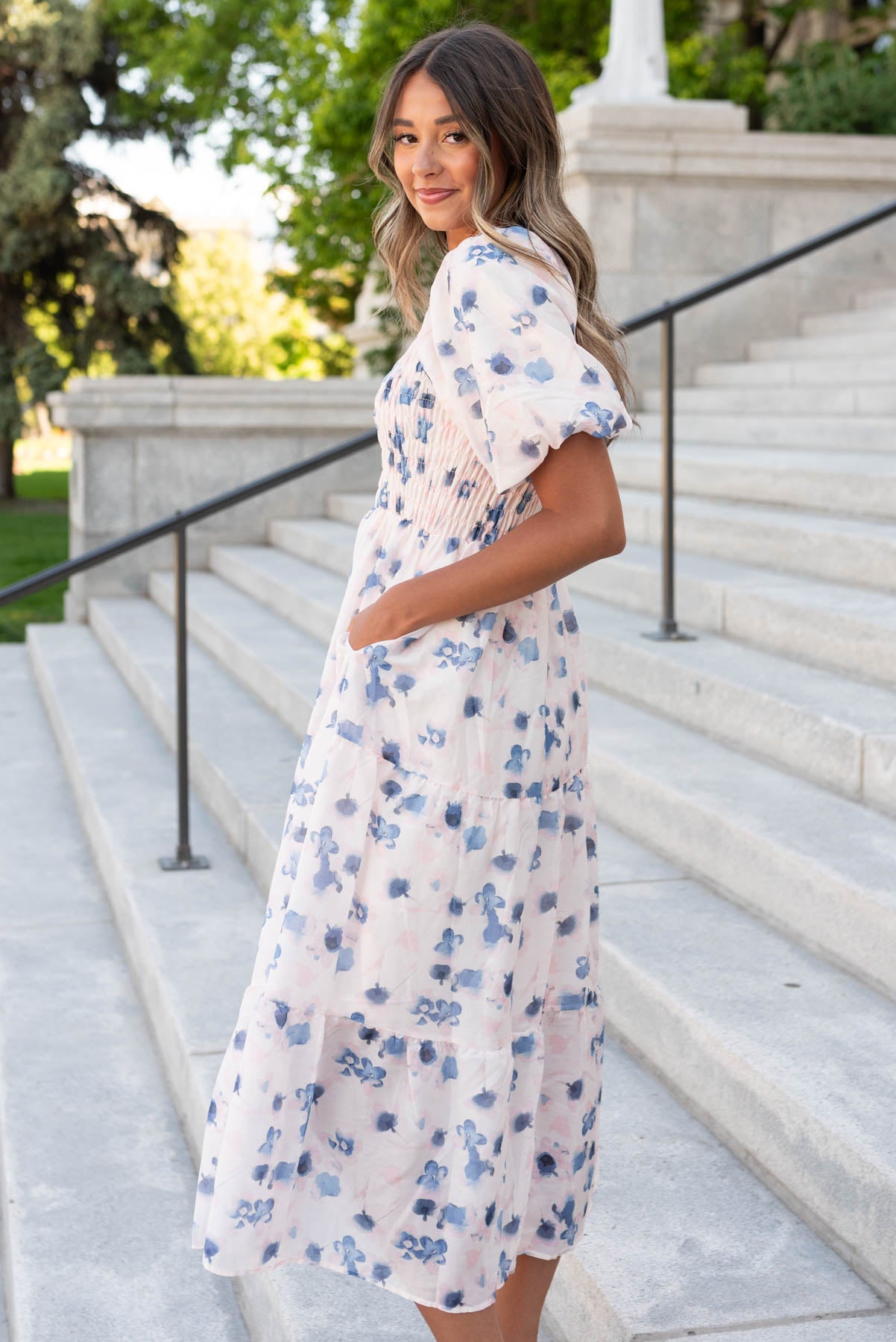 Side view of the blue floral smocked dress with pockets