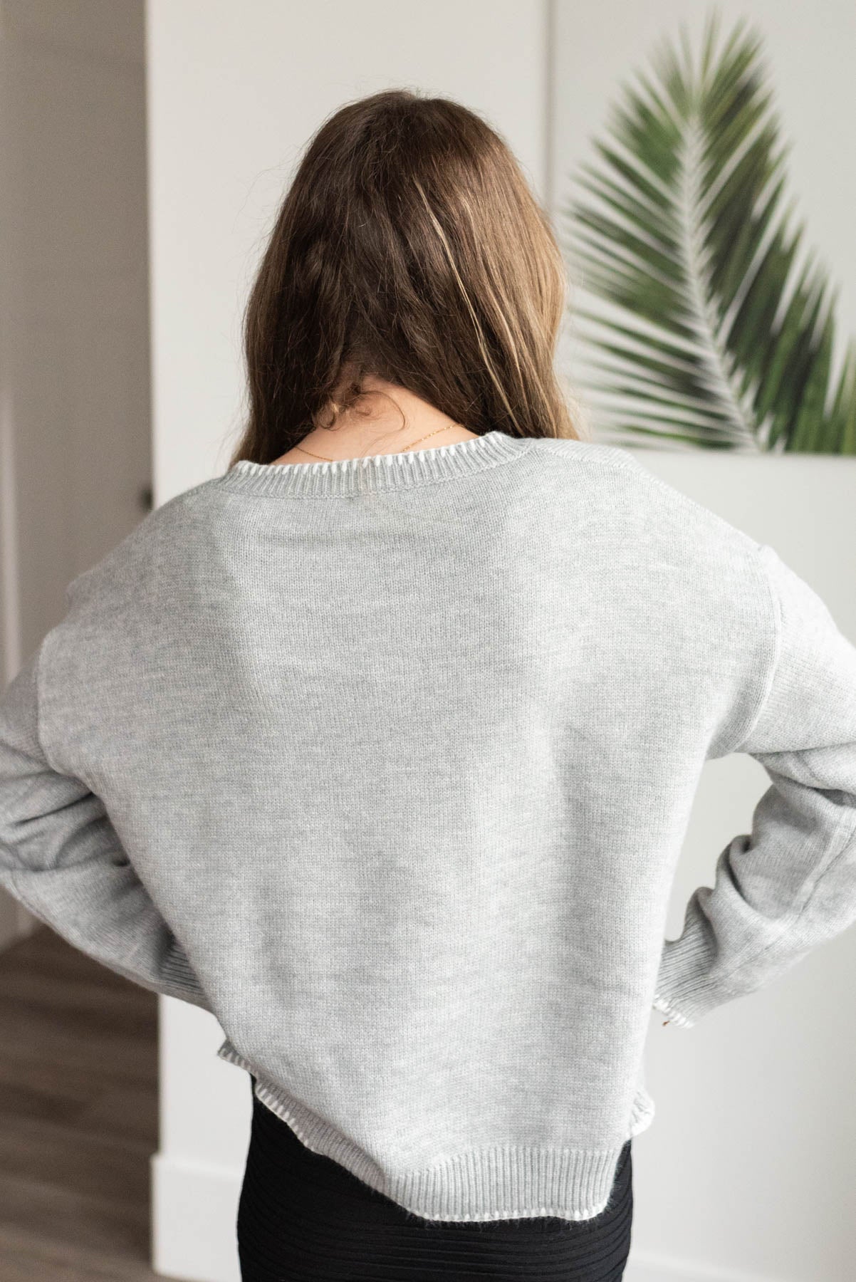 Back view of the heather grey bow sweater