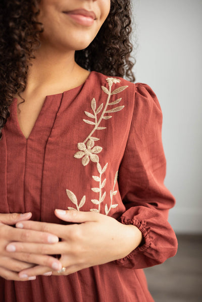 Close up of the embroidery on the burgundy embroidered floral dress