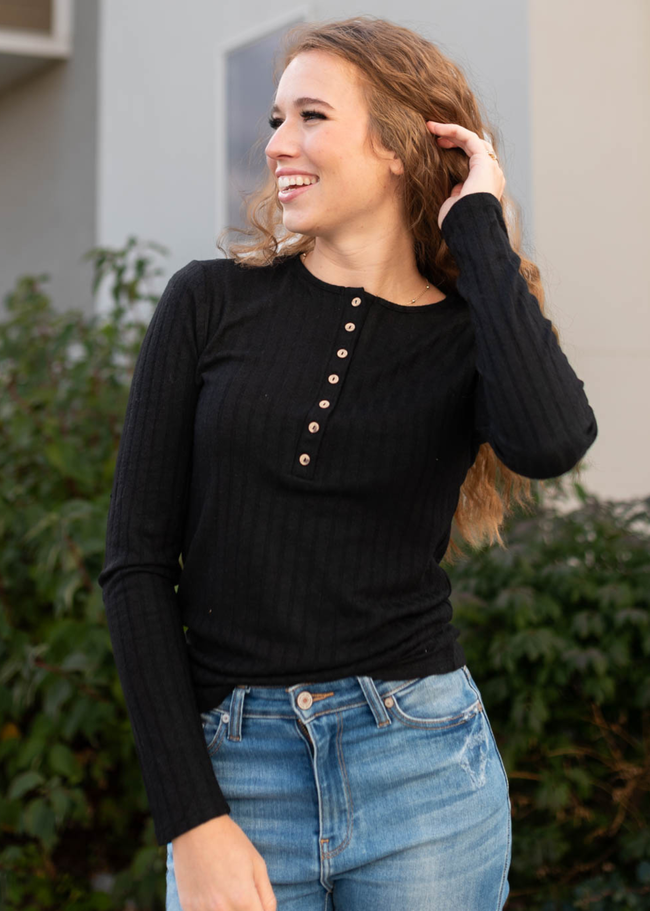  Buttons on a black ribbed long sleeve top