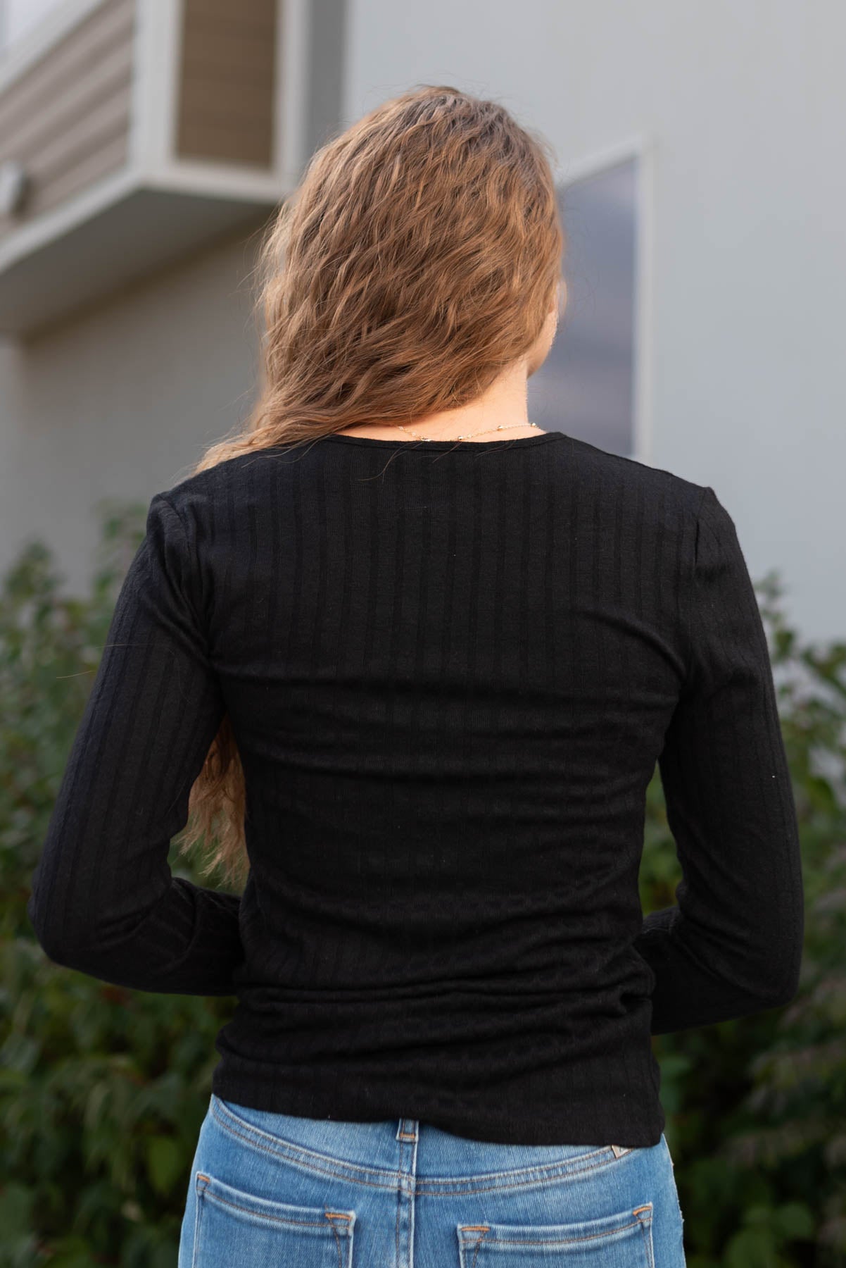 Back view of the black ribbed long sleeve top