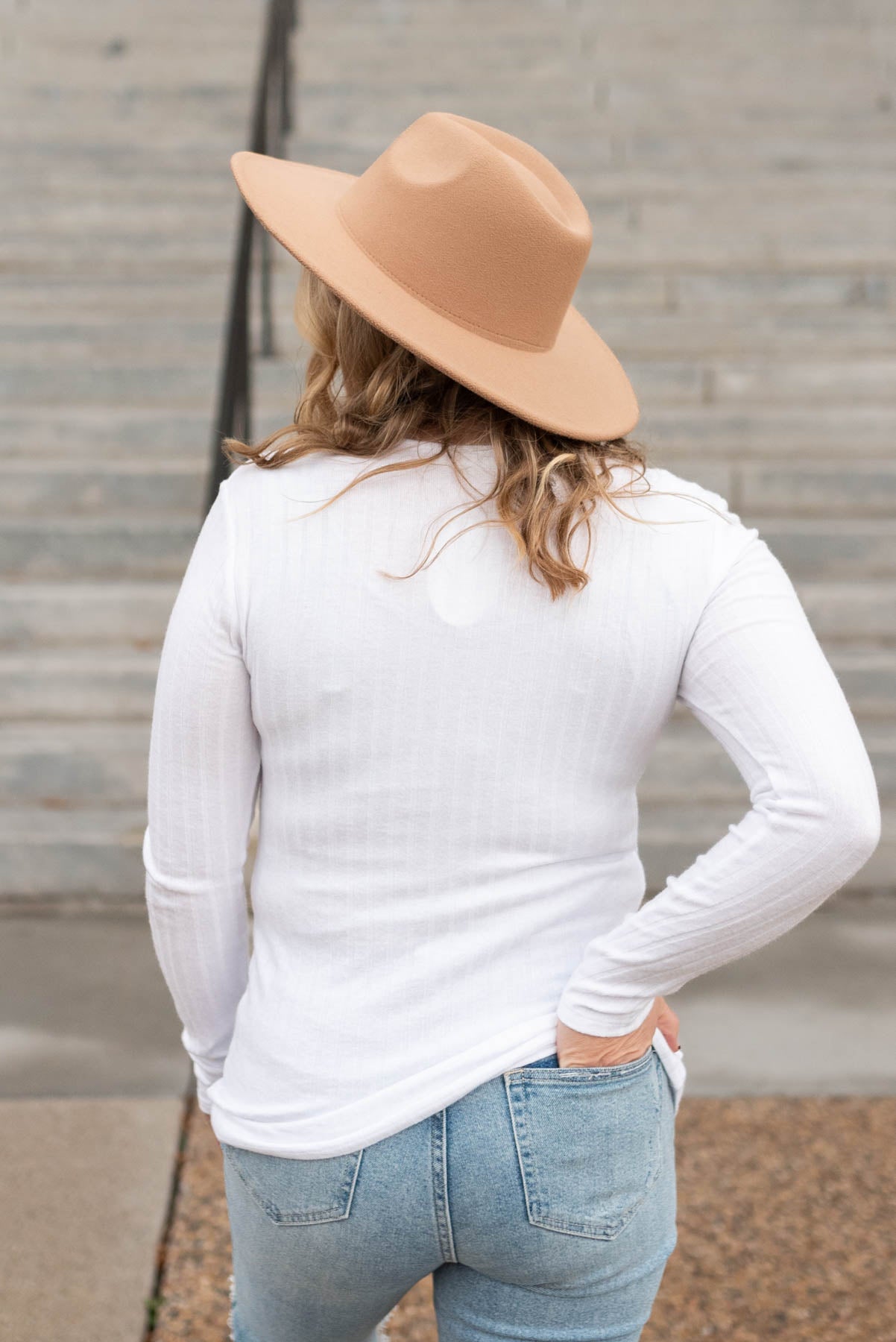 Back view of a off white ribbed long sleeve top