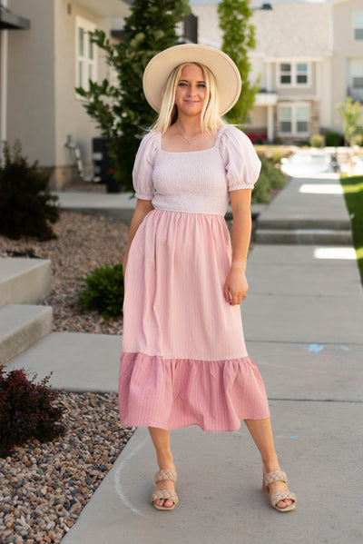 Pink dress with short sleeves and pockets with a smocked bodice