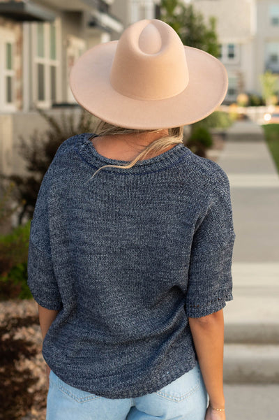 Back view of a short sleeve navy top