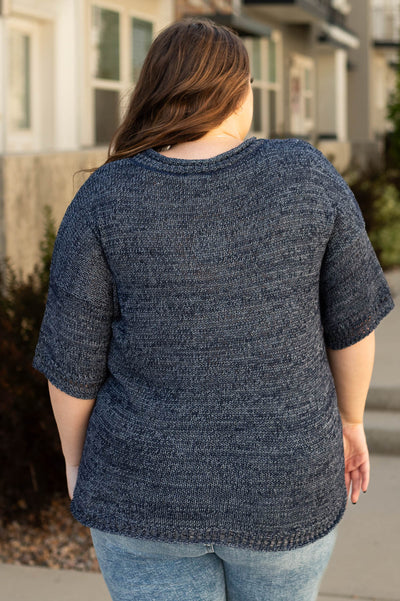 Back view of a plus size navy top