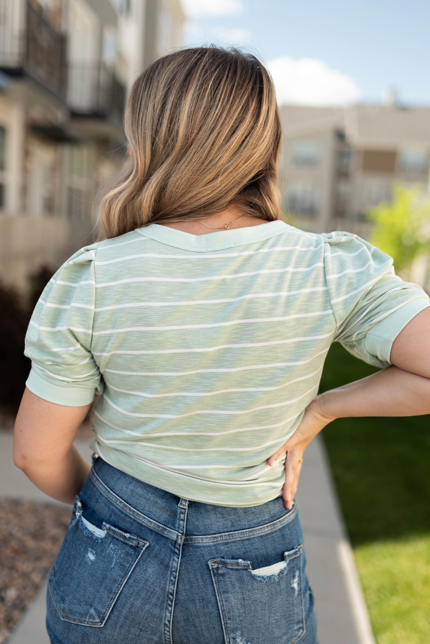 Back view of a sage stripe top