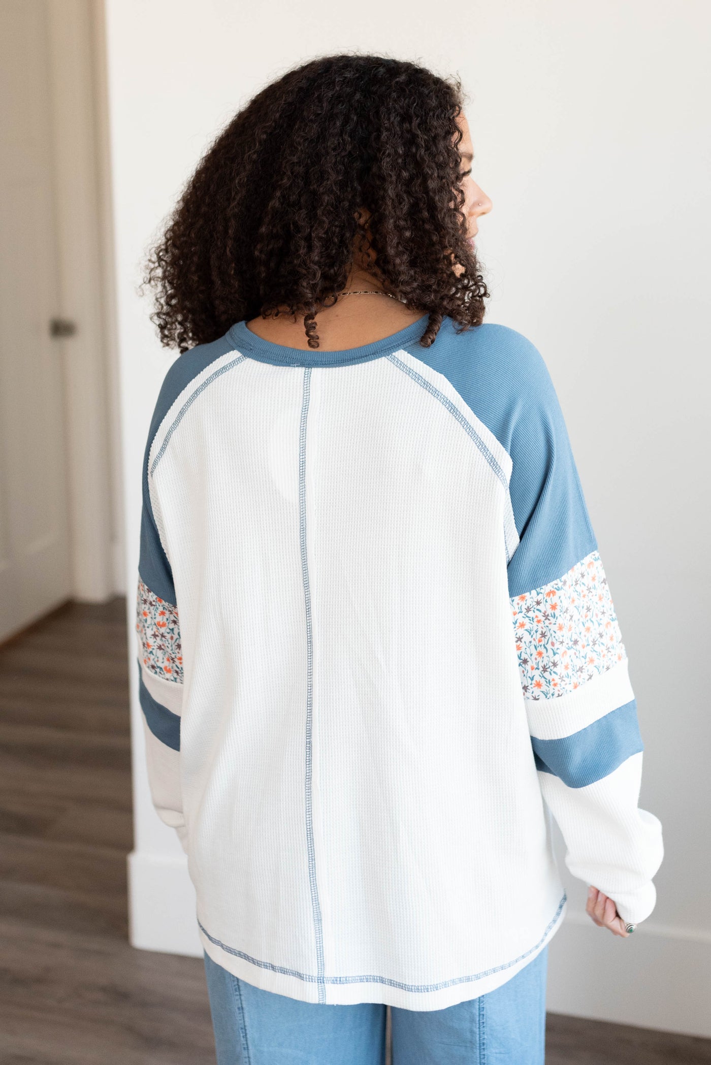 Back view of the blue floral patchwork long sleeve top