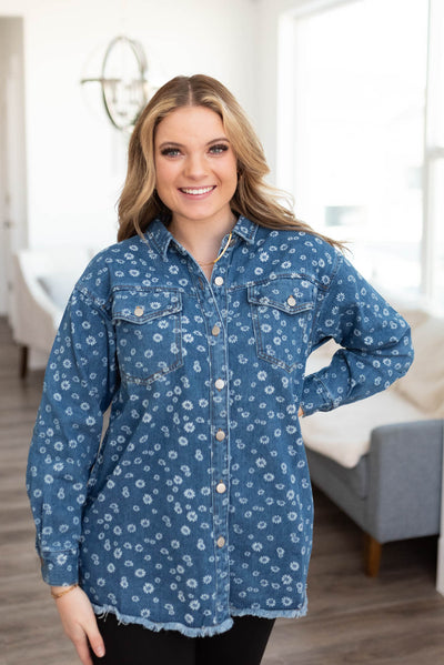 Front view of a denim blue button down top