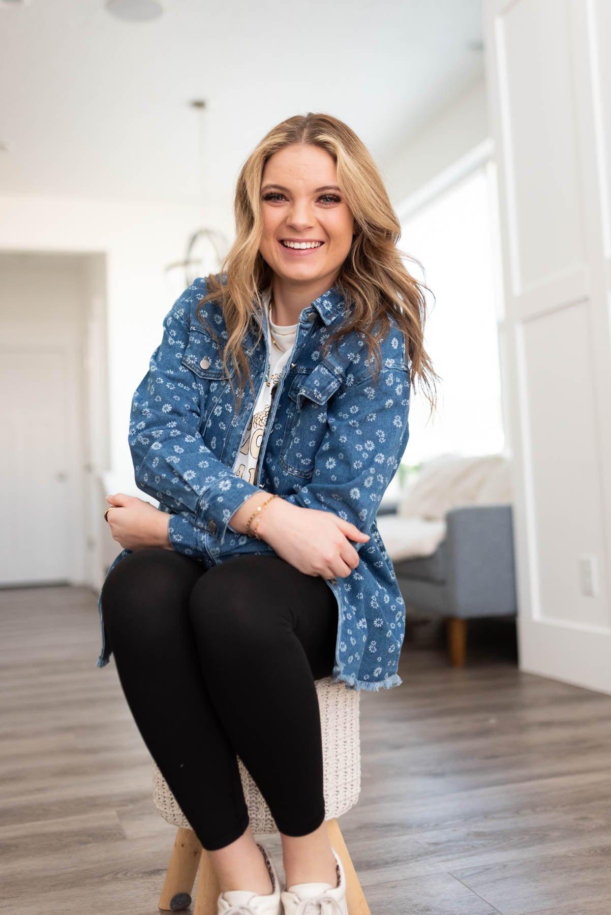 Denim blue button down top with front pocket and a floral print