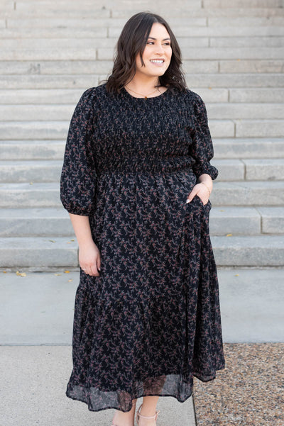 Plus size black pink flower dress with pockets and a smocked bodice