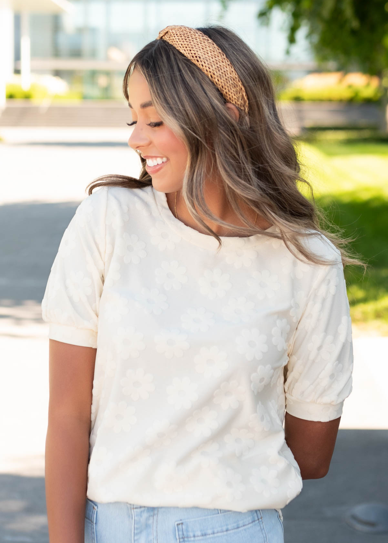 Close up of the floral pattern on the cream floral pattern top