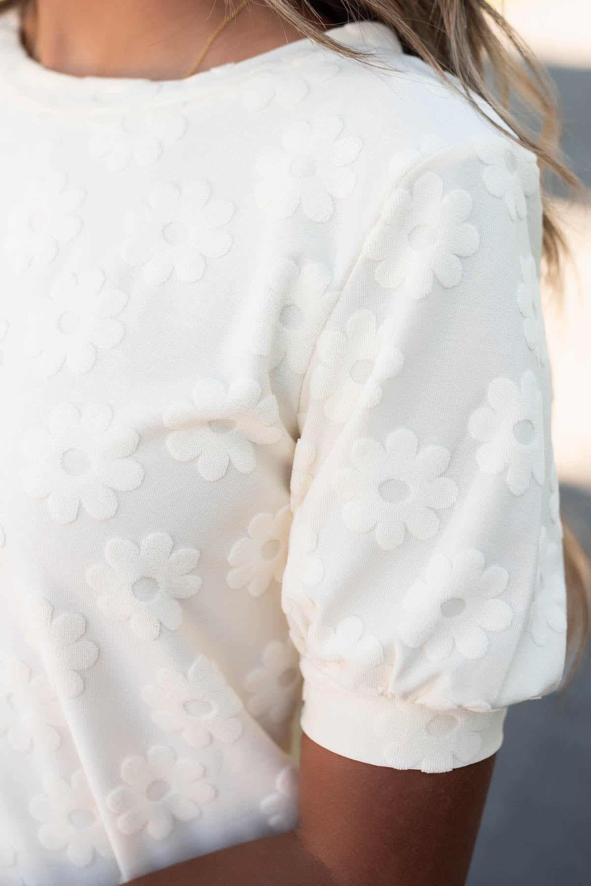 Close up of the sleeve on the cream floral pattern top