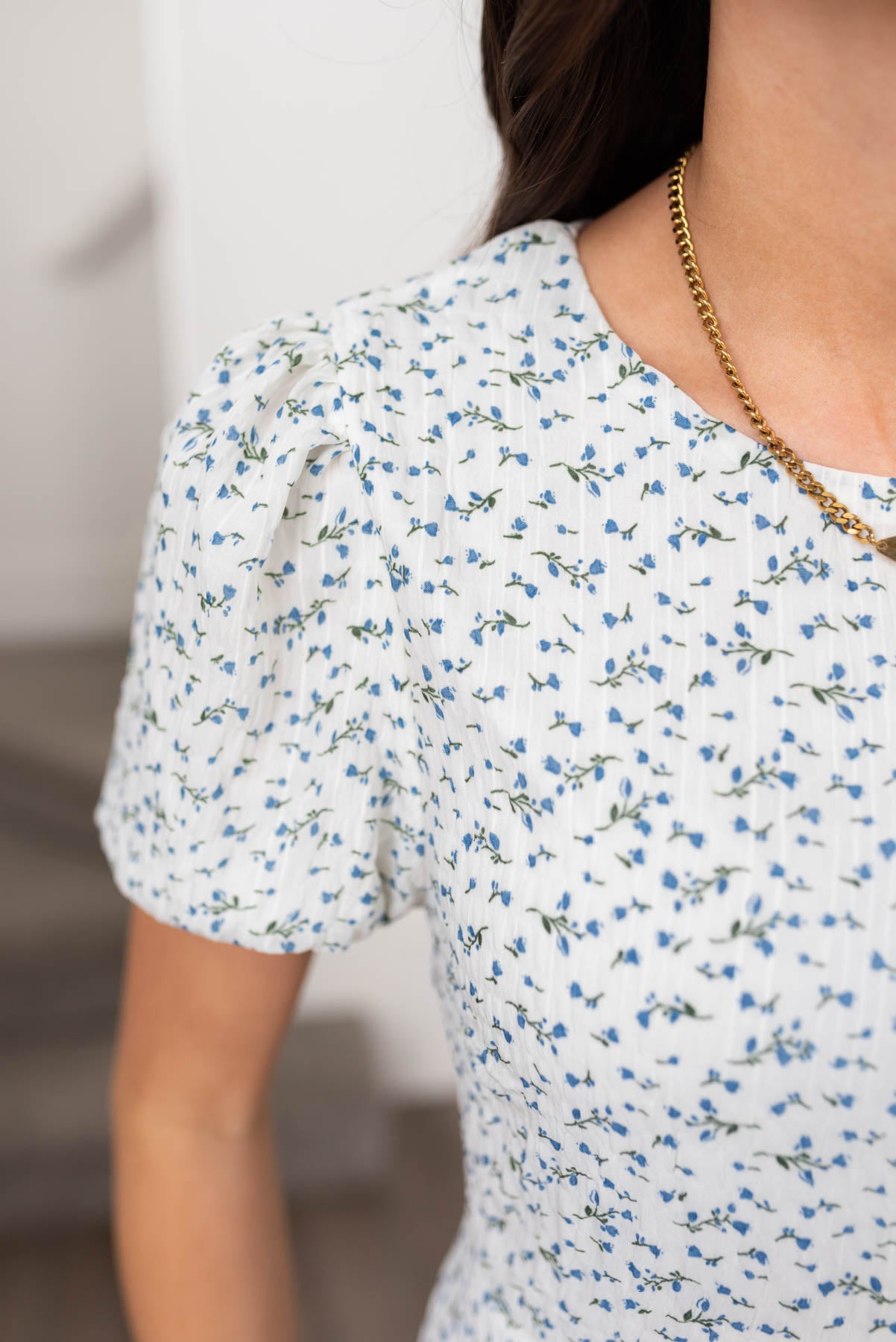 Close up of tha fabric and sleeve on the blue floral dress