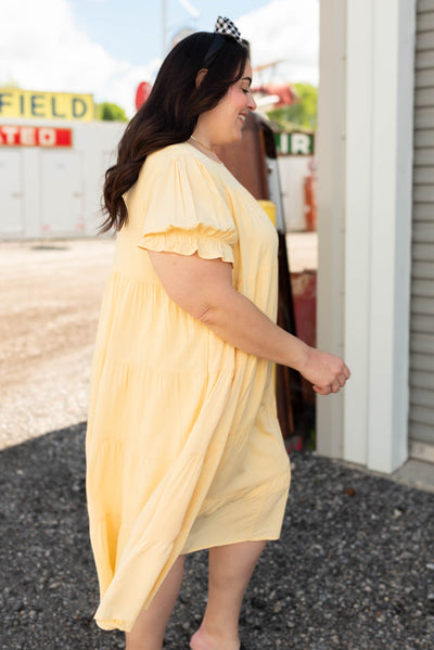 Side view of the light yellow tiered dress