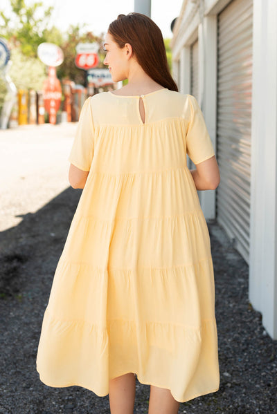 Back view of the light yellow tiered dress