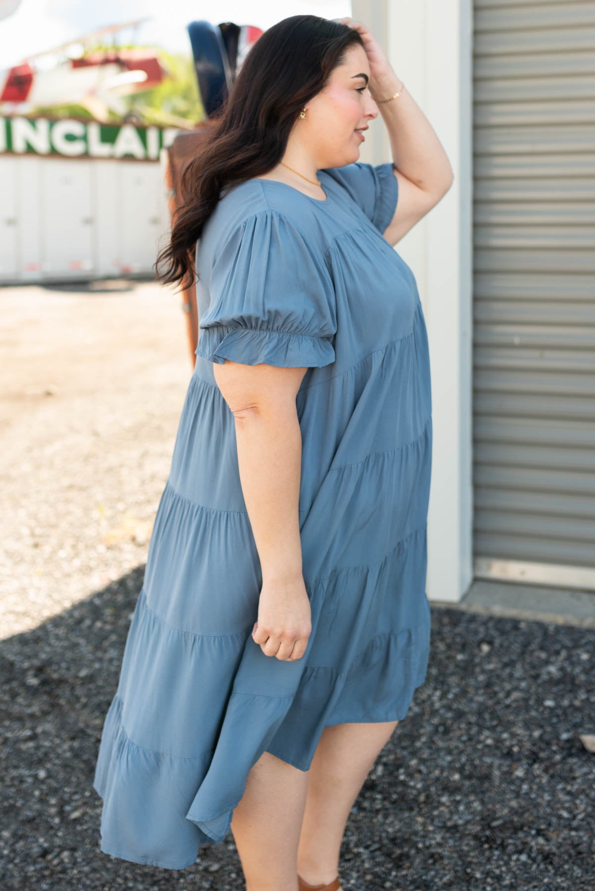 Side view of the plus size navy tiered dress