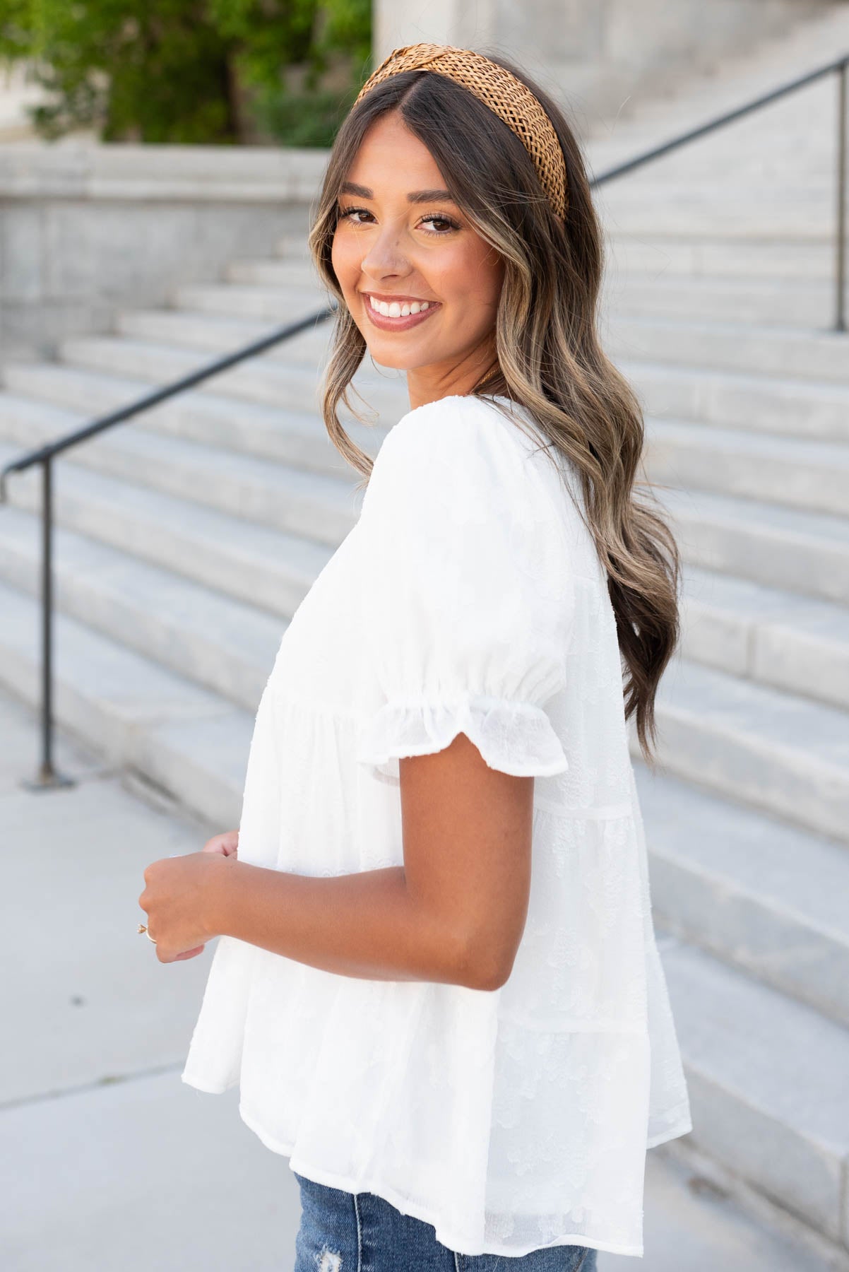 side view of the white floral ruffle top