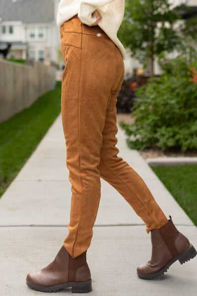 Side view of camel suede leggings