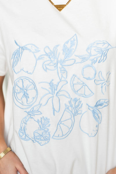 Close up of the light blue print on the lemon print graphic tee