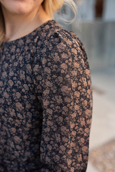 Close up of the fabric and sleeve on the navy multi floral dress