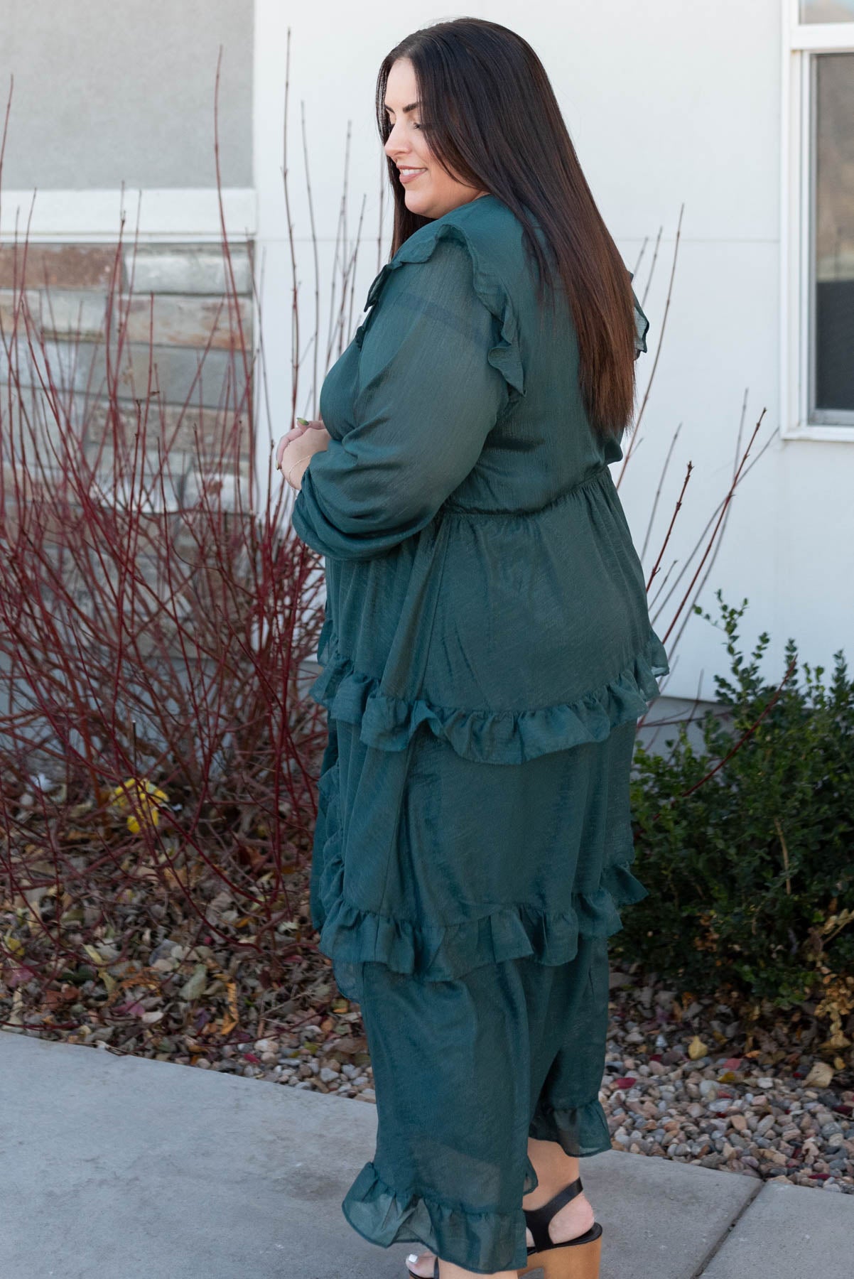 Side view of a hunter green tiered dress