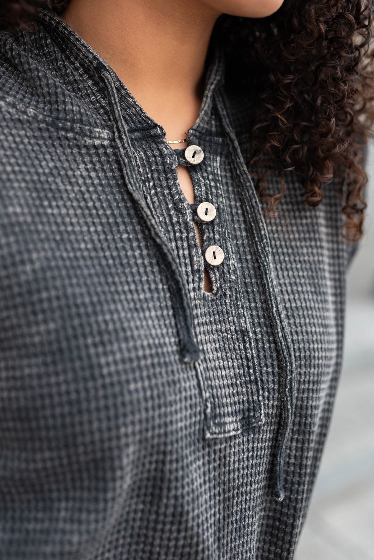 The buttons on a ash black waffle hoodie